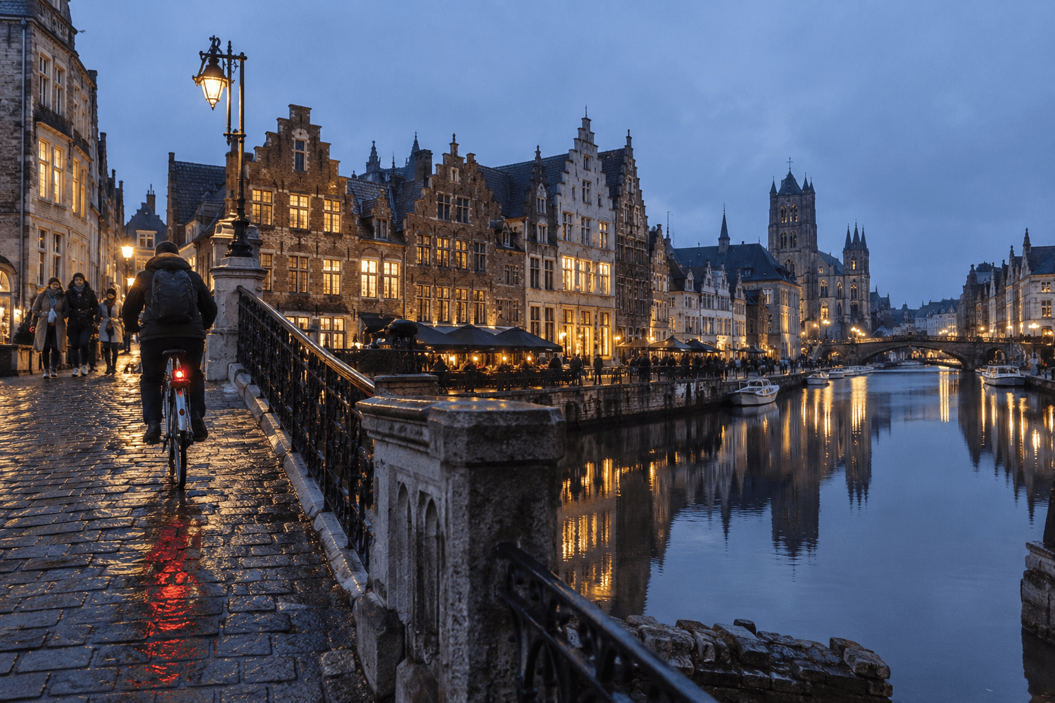 Cyclist beside the medieval canal quays of Ghent at blue hour