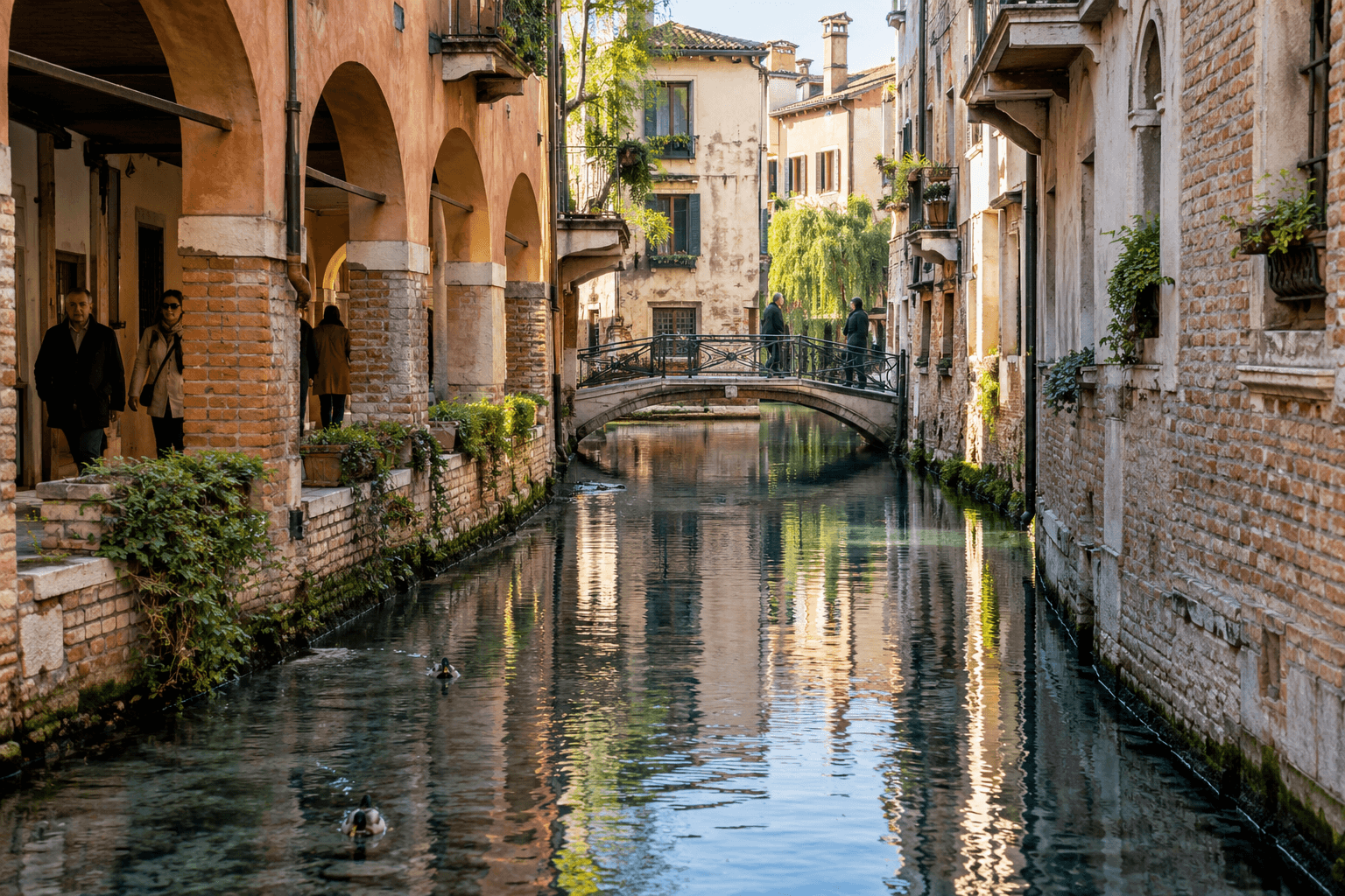 Photorealistic view of the Buranelli canals in Treviso with brick arcades, a footbridge, reflections and local pedestrians