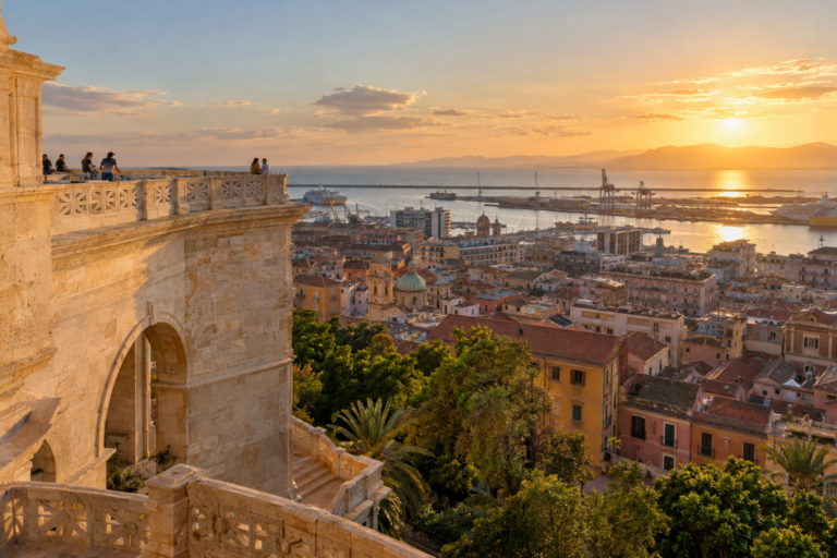 Cagliari harbour and historic rooftops at golden hour from the Bastione di Saint Remy