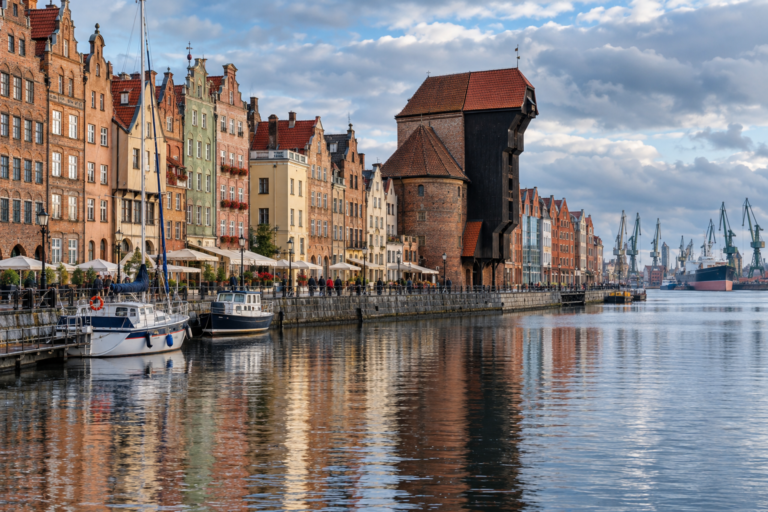Gdańsk Crane, Hanseatic gabled houses and boats reflected in the Motława on a cool Baltic morning