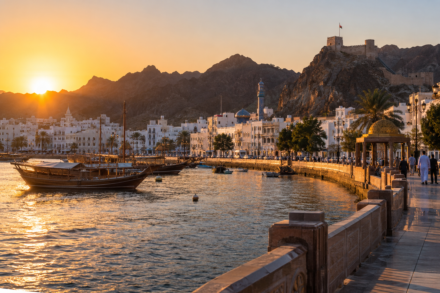 Muttrah Corniche, wooden dhows and hilltop fort at sunset in Muscat