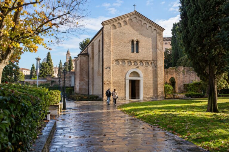 Visitors approaching the brick Scrovegni Chapel in Padua after morning rain